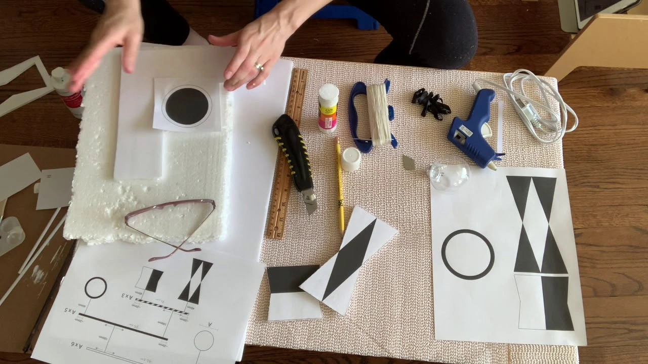 Hands balancing the top dowel of a DIY Munari mobile