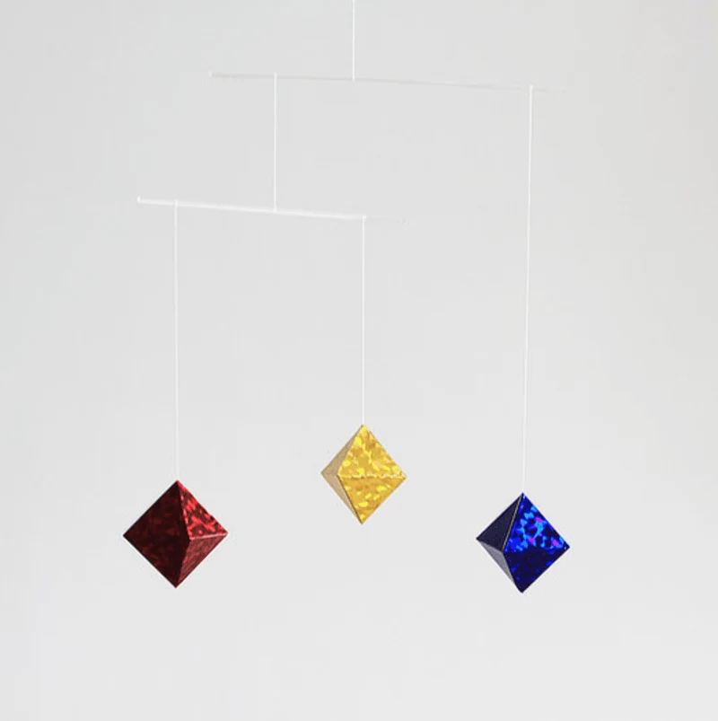 Montessori Octahedron mobile with red, yellow and blue reflective octahedrons