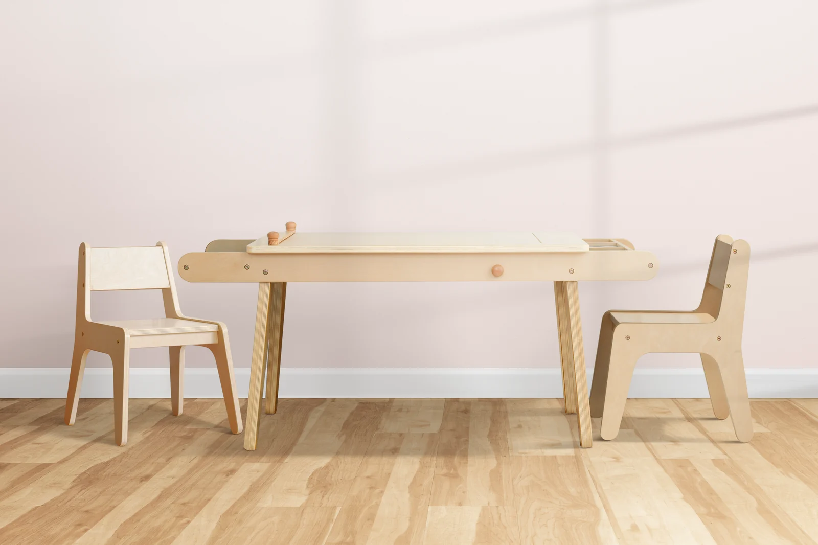 A small wooden table and chair next to a low shelf in a bright, simple room
