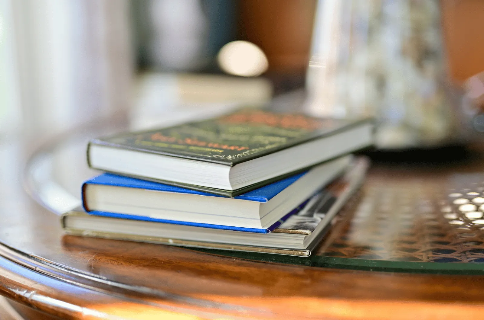 Small stack of Montessori parenting books on a side table, spines facing out