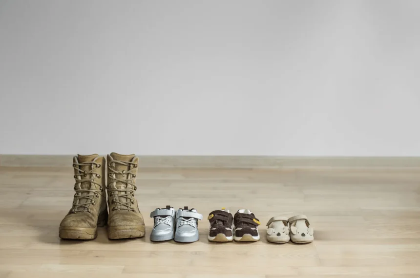 Four pairs of shoes in a row, from baby booties to grown-up sneakers, picturing the Montessori planes of development