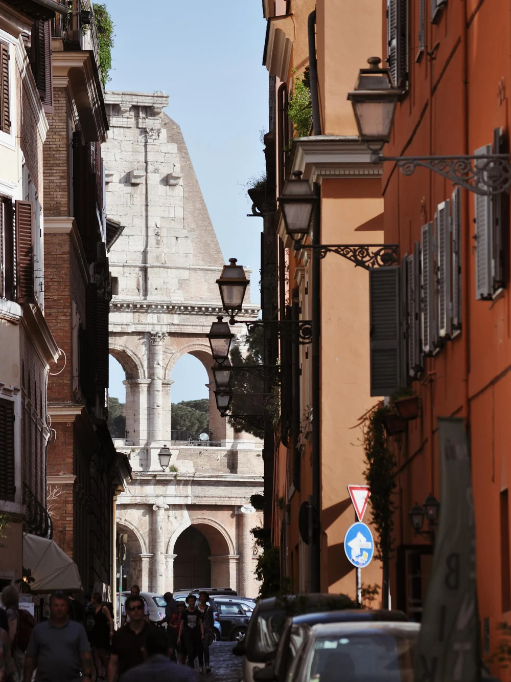 Old residential street in Rome with ochre buildings and green shuttered windows