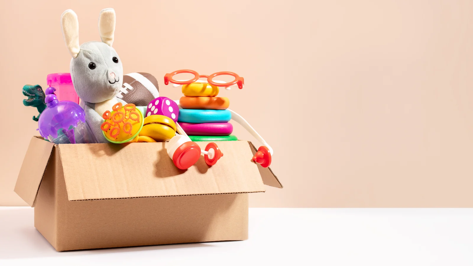 An overflowing toy box with toys piled up to the rim