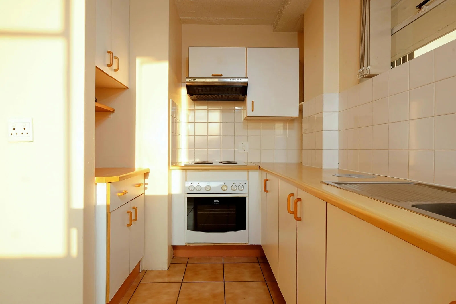 A small, narrow kitchen with little open floor space between the counters