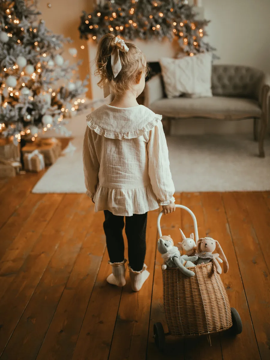 Toddler carrying a small woven basket across a living room
